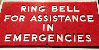 sign that says ring bell for assistance in emergencies