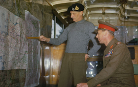 Field Marshal Sir Bernard Montgomery pointing out the German West Wall region to King George VI  color photos of World War II worldwartwo.filminspector.com