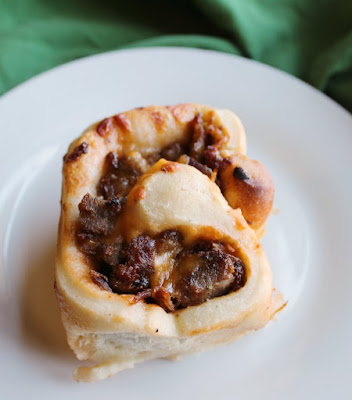 Turn BBQ pulled pork into something fabulous. These buns are a fun twist on the classic sandwich! soft and cheesy bbq pulled pork bun on plate ready to eat