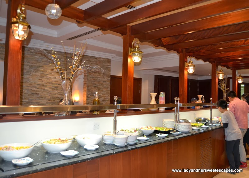 Asian buffet under a wooden pergola in Intramuros Dubai