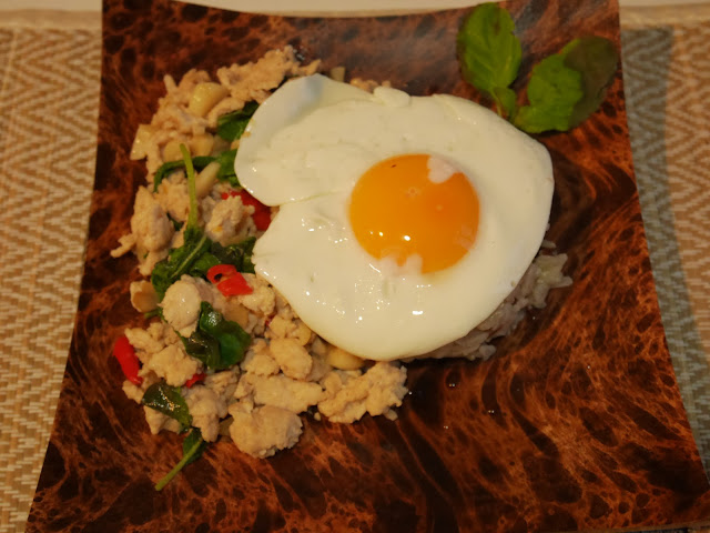 thai chicken basil dish with fried egg