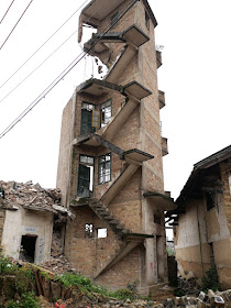 exposed stairway without railings leading up a partially demolished building