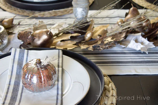 Beautiful farmhouse glam tablescape idea for fall decor and entertaining. I love the grainsack runner and the mercury glass candleholders!