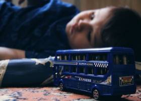 A depressed child who does not want to play with a toy. A depressed child who does not want to play with a toy.