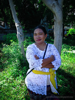 Woman In Traditional Balinese Clothes In The Area Of The Cemetery At Temukus Village, North Bali, Indonesia