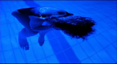 Juliette Binoche as Julie, swimming in the dark blue swimming pool at night, directed by Krzysztof Kieslowski