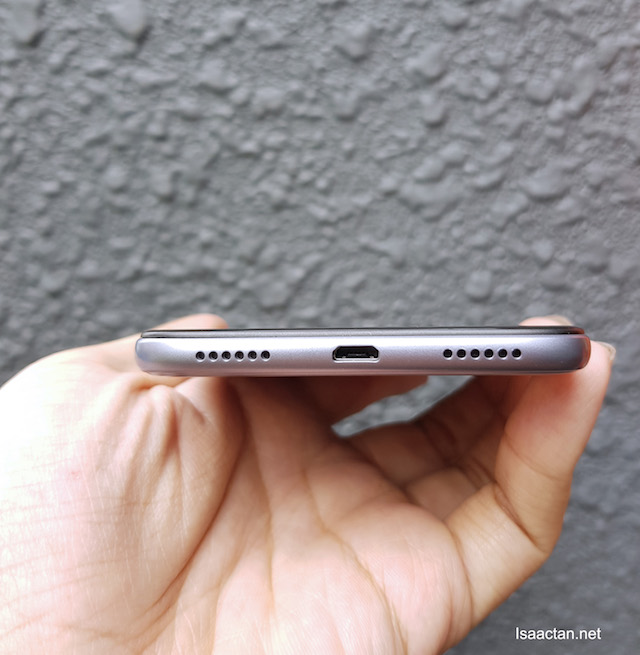 MicroUSB slot for charging, and a nice set of speaker grills on either side of it. MicroUSB slot for charging, and a nice set of speaker grills on either side of it.