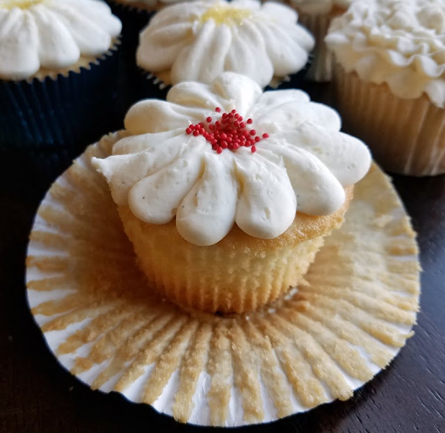 Fluffy white cupcakes are made perfect with a cake mix and a lot of add ins to make them special. They are the perfect texture, flavor and will quickly become your favorites as well!