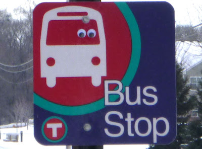 bus stop sign with googly eyes