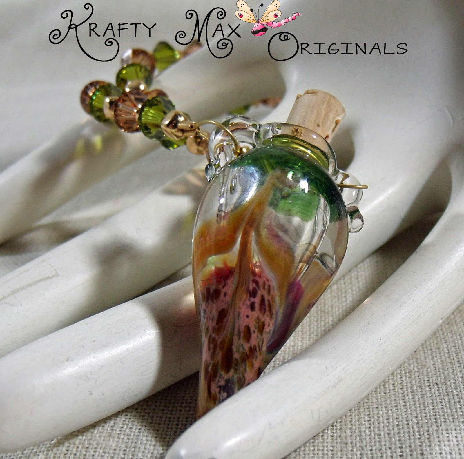 http://www.artfire.com/ext/shop/product_view/KraftyMax/9039649/isinglass_designed_lampwork_bottle_and_swarovski_crystal_necklace_set/handmade/jewelry/sets/lampwork