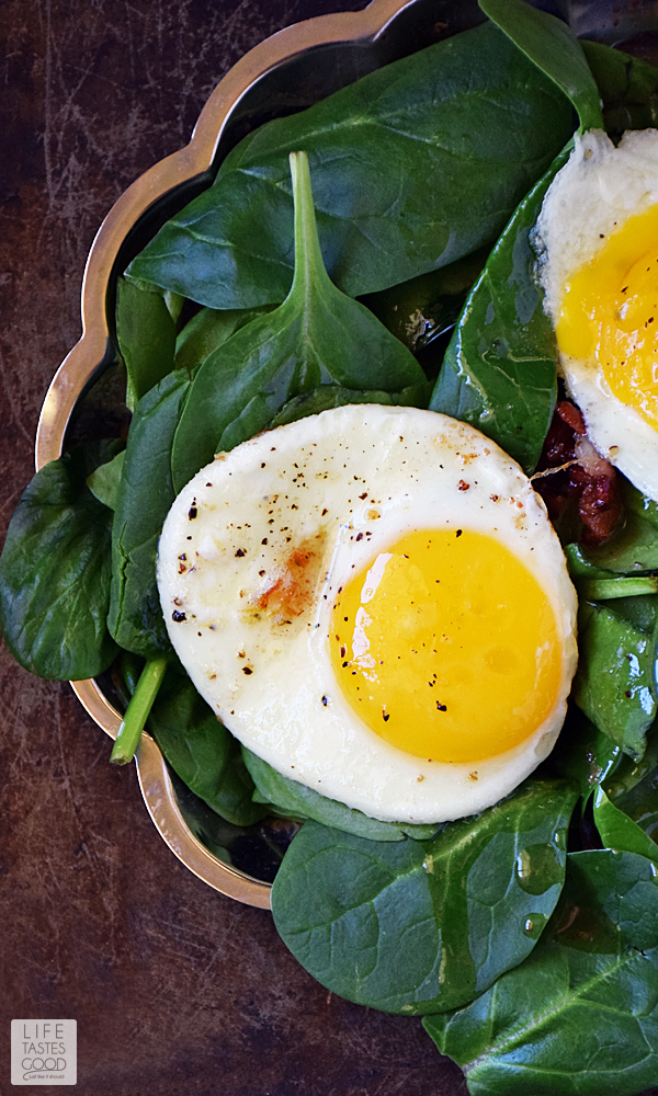 This Low Carb Spinach Breakfast Salad | by Life Tastes Good is a warm comforting way to start the day. Drizzled with Hot Bacon Dressing and topped with a perfectly fried egg, this salad tastes great in addition to being high in protein, and low in carbs. Did I mention it's quick and easy to make too! Winner! #LTGrecipes #SundaySupper