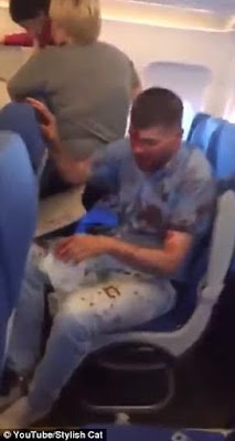 8a Disturbing video of drunken plane passenger covered in blood after he suddenly starts screaming and punching seat in front of him