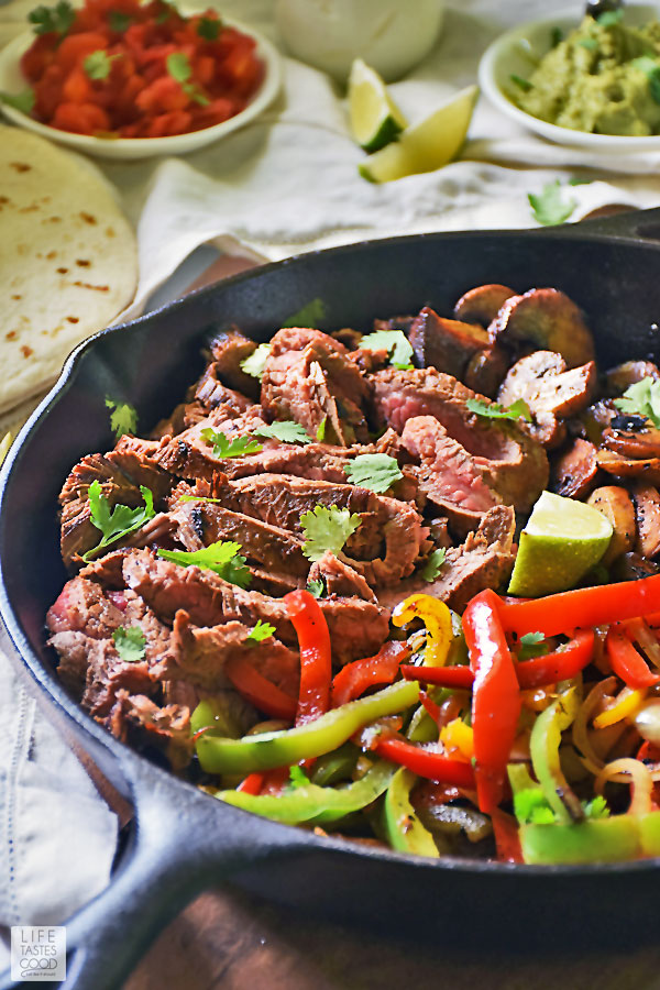Flank Steak Fajitas Recipe - flank steak and vegetables in cast iron skillet ready to enjoy
