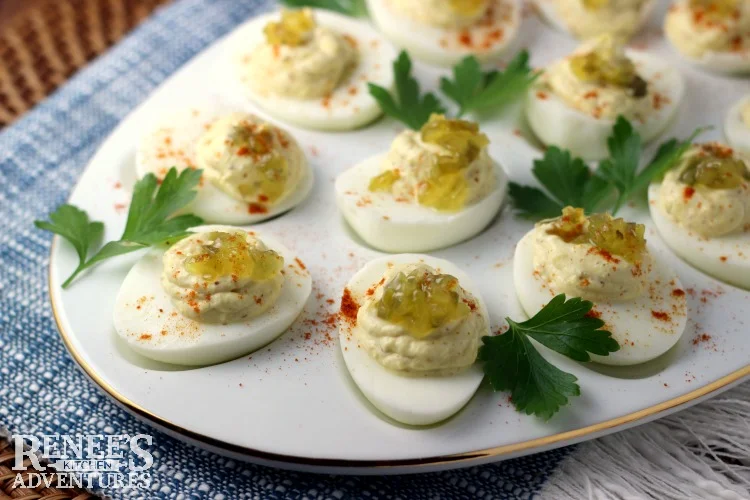 Sweet Relish Deviled Eggs by Renee's Kitchen Adventures on white platter with parsley garnish 