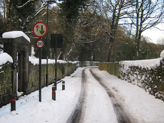 A snowy Ouseburn Road with an entrance to Armstrong park on the left