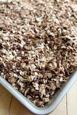 This toasty delicious chocolate granola is out of this world delicious. It is great eaten by the handful, sprinkled on yogurt or eaten as cereal with milk! Whatever you do, just make some! tray of chocolate coconut granola fresh from the oven