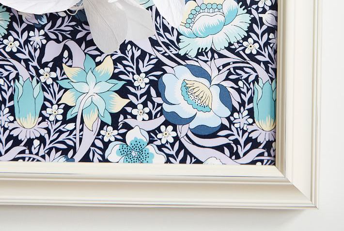 Use a fabric pinboard for flawless photo hanging.