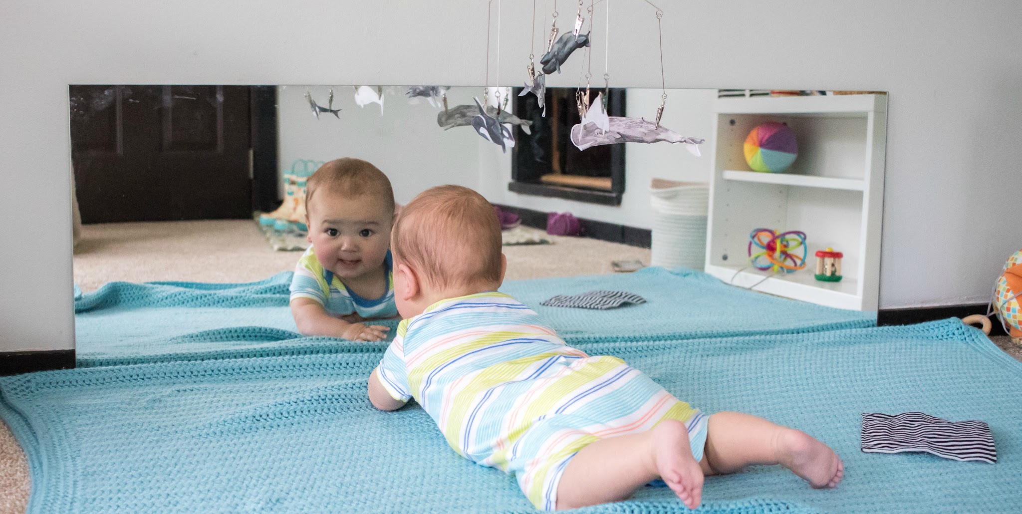 Babies love mirrors, and a long, low mirror is a staple in a Montessori baby environment.