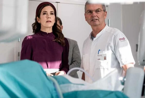 Crown Princess Mary attended the opening of Viborg Regional Hospital's new emergency center. burgundy blouse, grey midi dkirt, grey wool coat