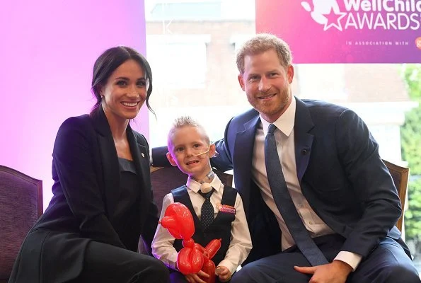 Meghan Markle wore Altuzarra Acacia blazer and wool Pants, Deitas Coco shantung camisole, Aquazzura pumps, carries Stella McCartney Bag