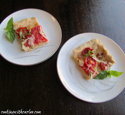 two small square pieces of tomato slab pie with cornmeal crust