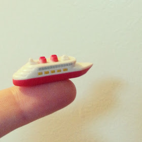 Disney miniature cruise ship on a finger tip.