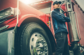 truck driver standing next to truck