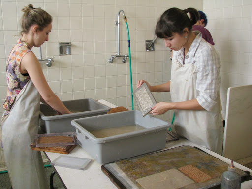 Two students mold paper 