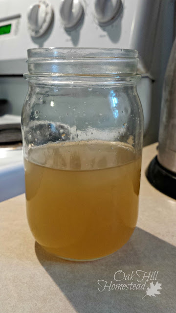 A quart canning jar with ginger tea, cooling to room temperature.