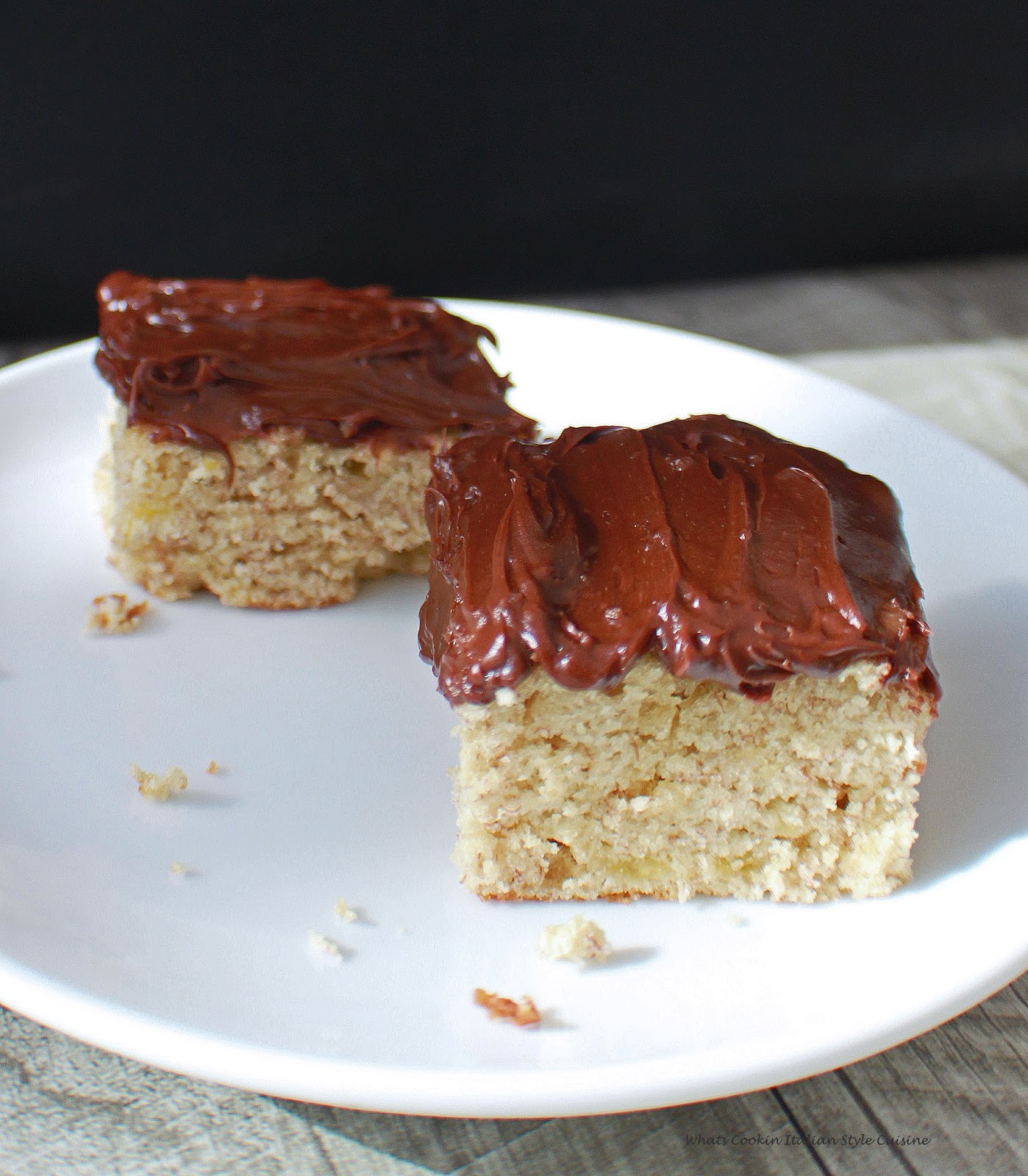 banana cake on a white plate with mocha frosting