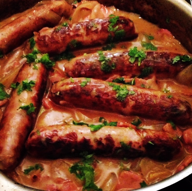 Sausages braised with Cider & Smoky Bacon