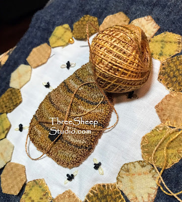 A Bee Skep surrounded by golden yellow honeycomb and a smattering of bees - 'The Hive' punch needle and wool applique pattern by Rose Clay at ThreeSheepStudio.com A Bee Skep surrounded by golden yellow honeycomb and a smattering of bees - 'The Hive' punch needle and wool applique pattern by Rose Clay at ThreeSheepStudio.com