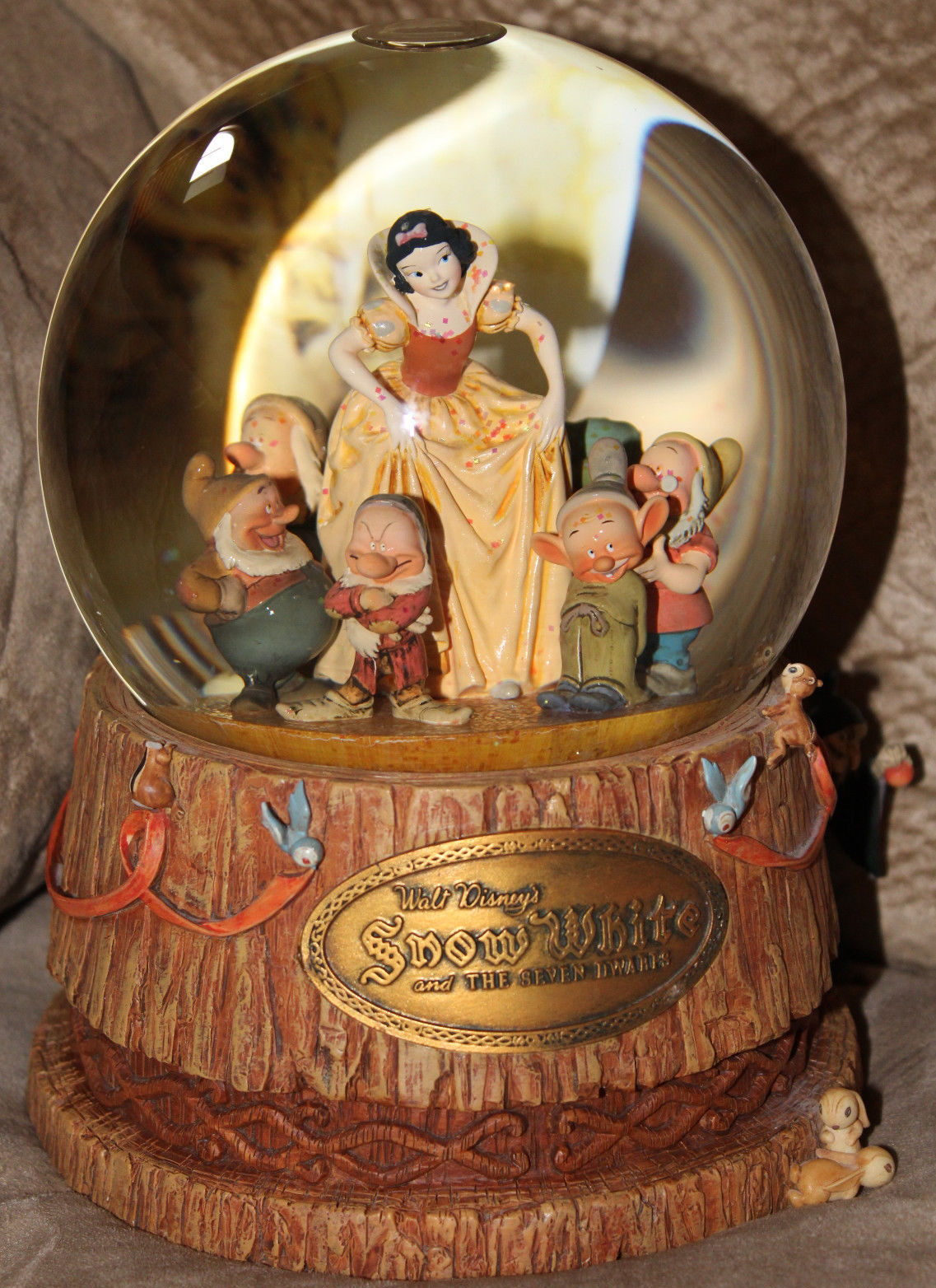 Snow globe featuring a figure dressed in the 1947 haute-…