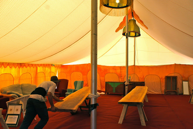 A farmer loads in the redwood tables...