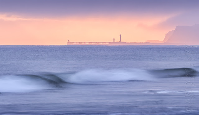 Photograph of Whitby piers in the morning fog at sunrise by Martyn Ferry Photography