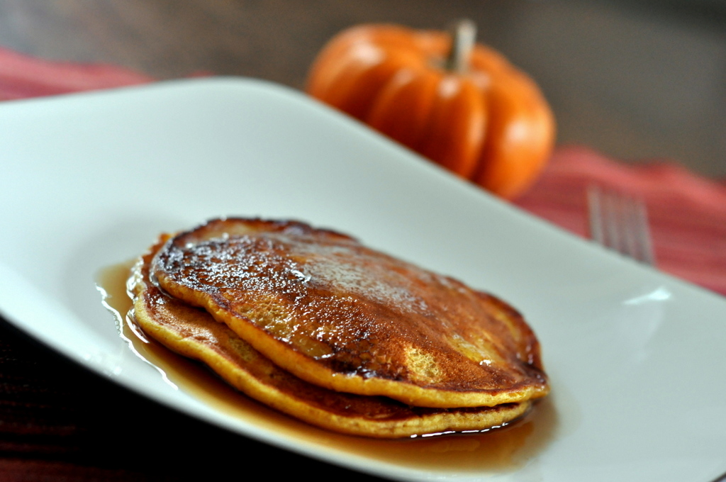Plate of Pumpkin Pie Pancakes with Mini Pumpkin in the Background | Taste As You Go