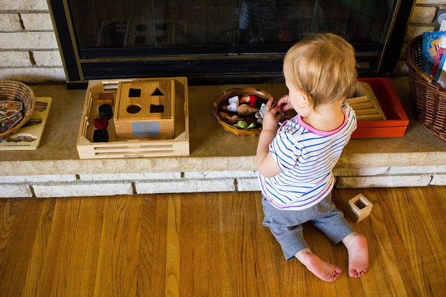 A look at a Montessori play shelf at 23 months old! Here are some Montessori friendly toy ideas for nearly 2-year-olds. 