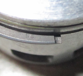 Close up of the "25" mark on the second piston ring - Yamaha two stroke