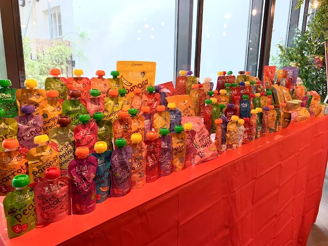 A display showing all the Ella's Kitchen products including lots of different pouches, snacks and other food in colourful packaging