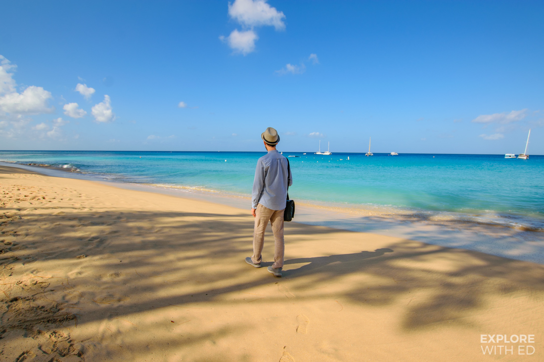 Travel blogger Explore With Ed walking along the beaches of Barbados