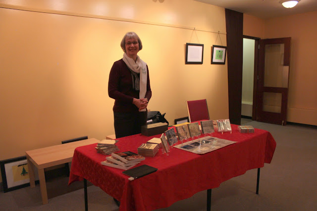 Michèle stands watch over the CD table as Front of House director