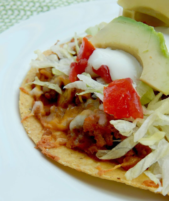 Oven Baked Tostadas...a simple, fun family meal!  Crunchy tostadas are layered with ground beef, refried beans and cheese and then topped with all the toppings! (sweetandsavoryfood.com)
