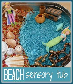 A beach and underwater themed sensory tub for children