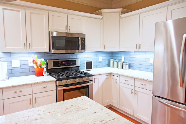 Before and After White Kitchen Renovation - painted cabinets, River White Granite, Datile Enchanting Impressions Paint Brush Glass Tile in Gray. We did it all for under $10K!