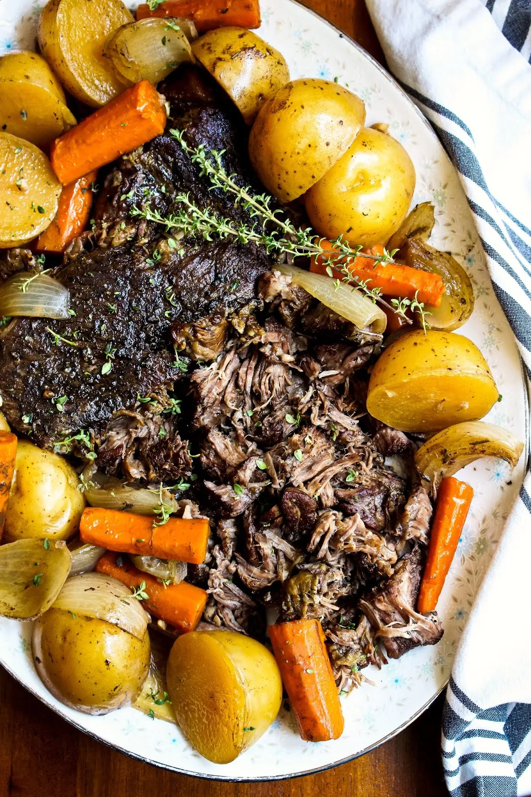 This Perfect Slow Cooker Pot Roast is simmered in the slow cooker to tender perfection!  It is a classic no-fuss dinner that is great for busy weeknights or Sunday supper. #potroast #chuckroast #dinnerrecipe #slowcooker