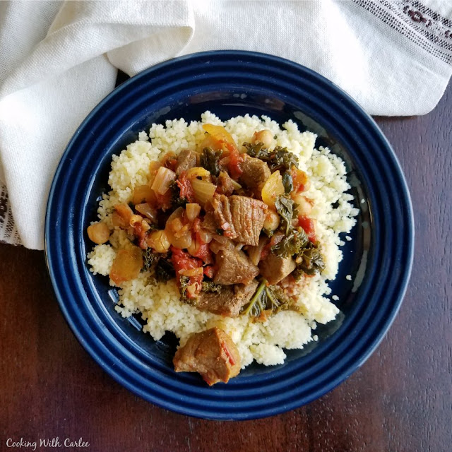 Moroccan Lamb Stew is hearty, flavorful and warm. It is perfect nestled on a bed of couscous and is sure to leave you full and satisfied. plate of couscous with lamb stew piled on top
