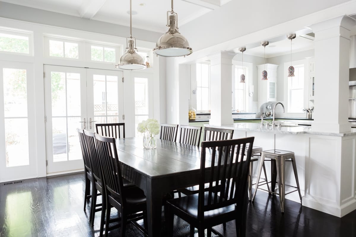 Breakfast area in modern farmhouse kitchen with black floors on Hello Lovely Studio