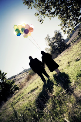 Couple walking with balloons