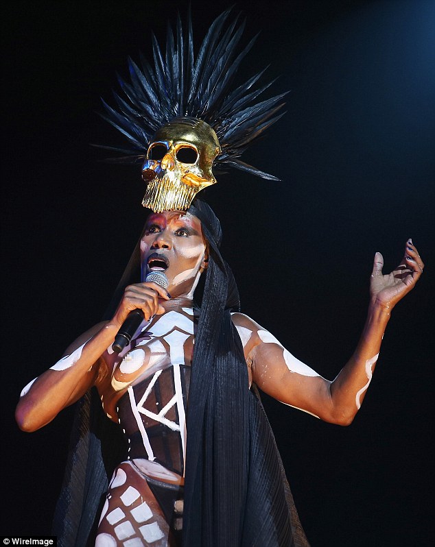 67 year old Grace Jones performs topless in tribal body paint.