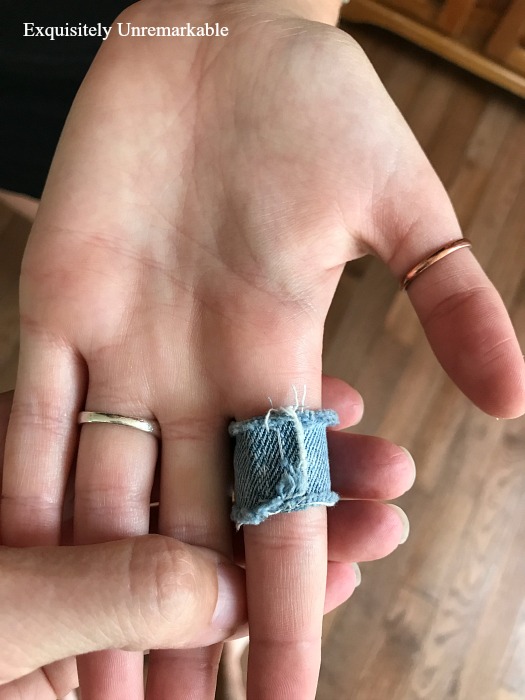 Back of denim ring that has been stitched up to fit finger